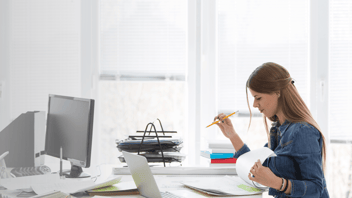Woman completing paperwork at a work from home desk