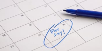 calendar with the words pay day written and circle in blue marker