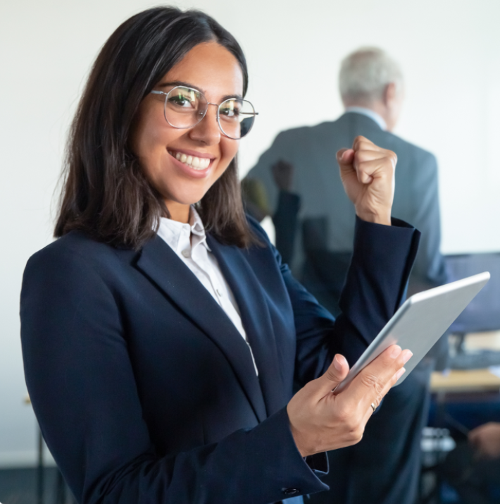 woman holding a tablet in her hand making a gesture that she is excited about something