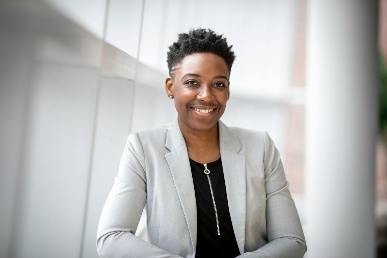 short haired person smiling at camera