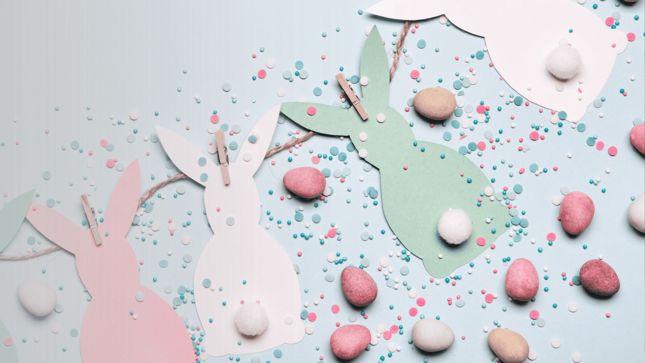 a pink background with 4 sets of white and pink bunny ears
